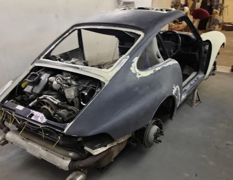Classic car bodyshell stripped back to filler and primer in the John Bee workshop before painting