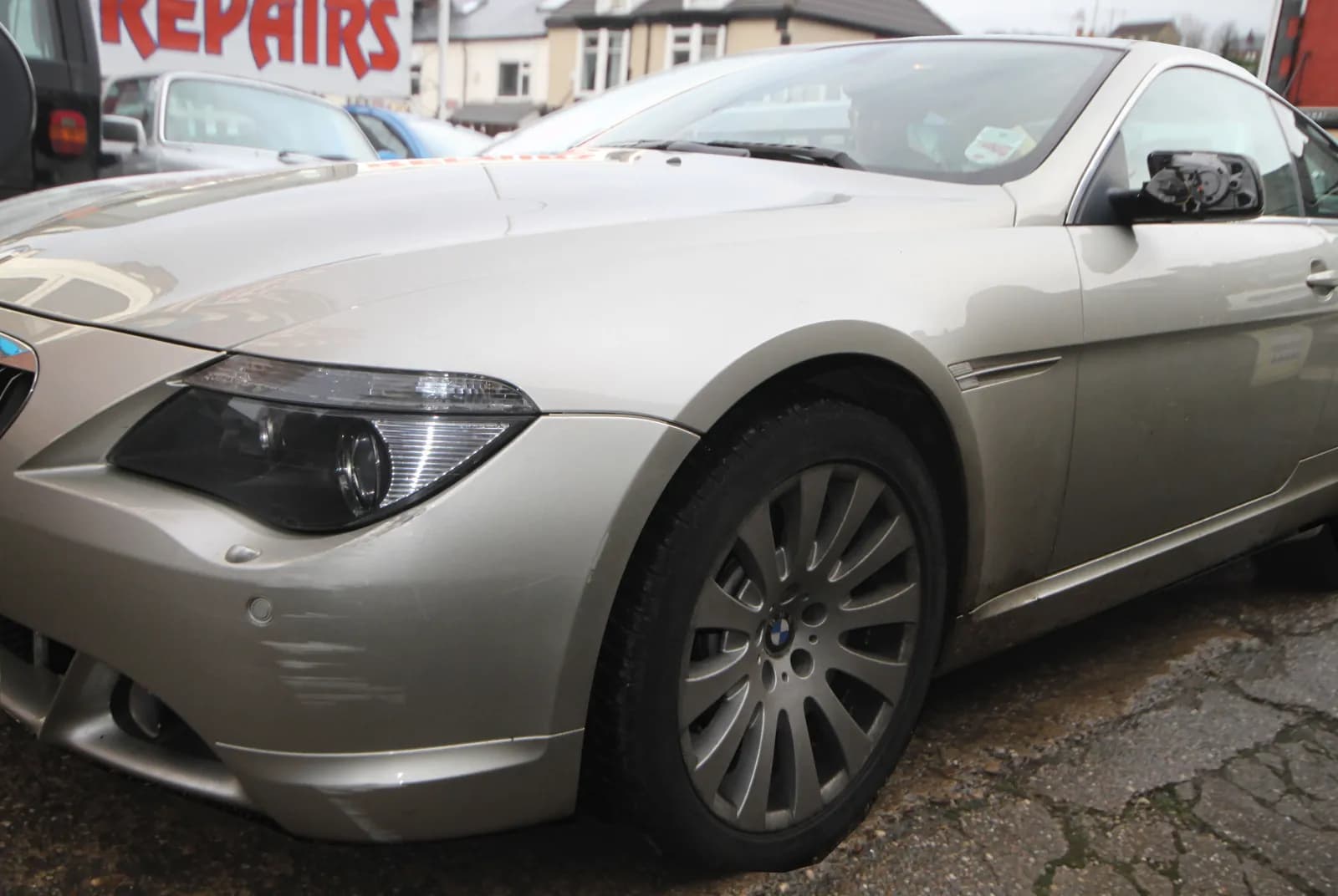 Silver BMW 6 Series with a dent in the front wing before paintless dent removal