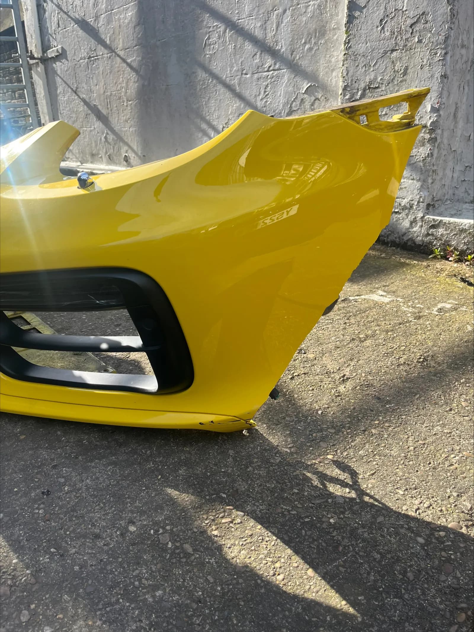Yellow Porsche Boxster front bumper cover removed from the car