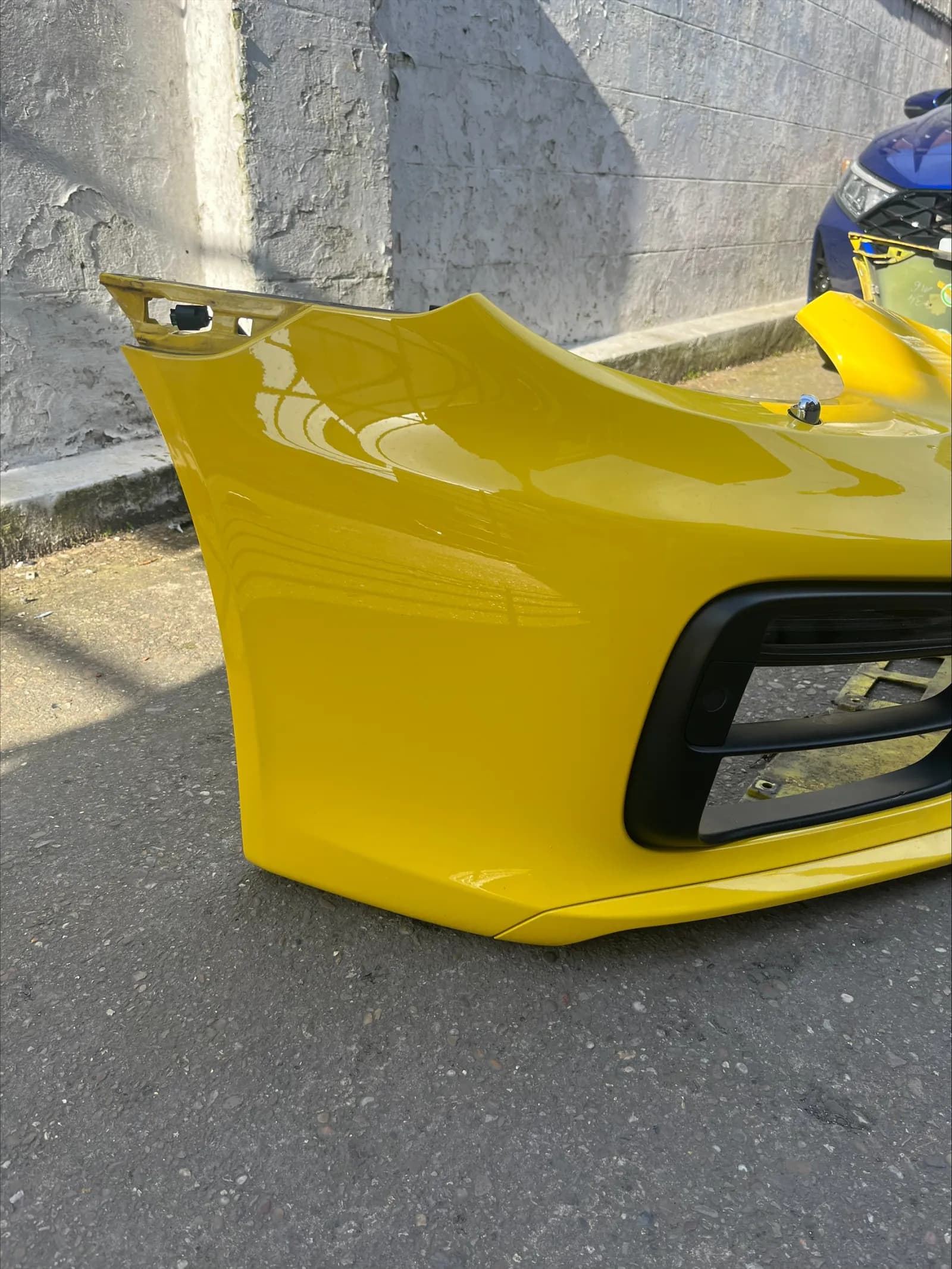 Yellow Porsche Boxster front bumper cover ready for repair