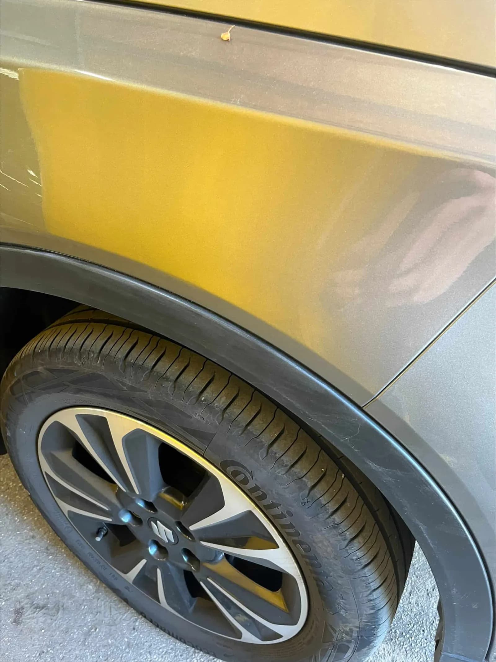 Suzuki Vitara wing and wheel photographed outdoors in sunlight